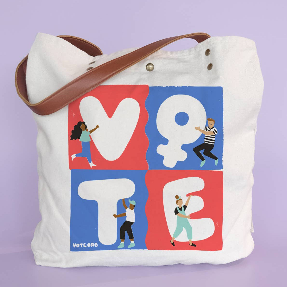 A white canvas tote bag with a brown shoulder strap, featuring a colorful 'VOTE' graphic on the front with illustrated people and small 'VOTE.ORG' text, set against a solid lavender background.