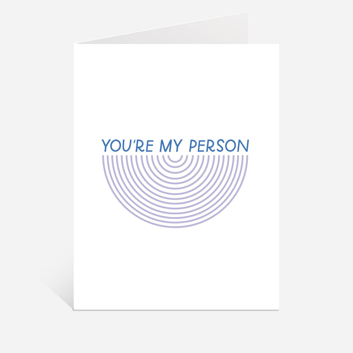 A white greeting card with a blue graphic design that reads 'YOU'RE MY PERSON' above concentric semi-circular lines, shown on a light gray background.