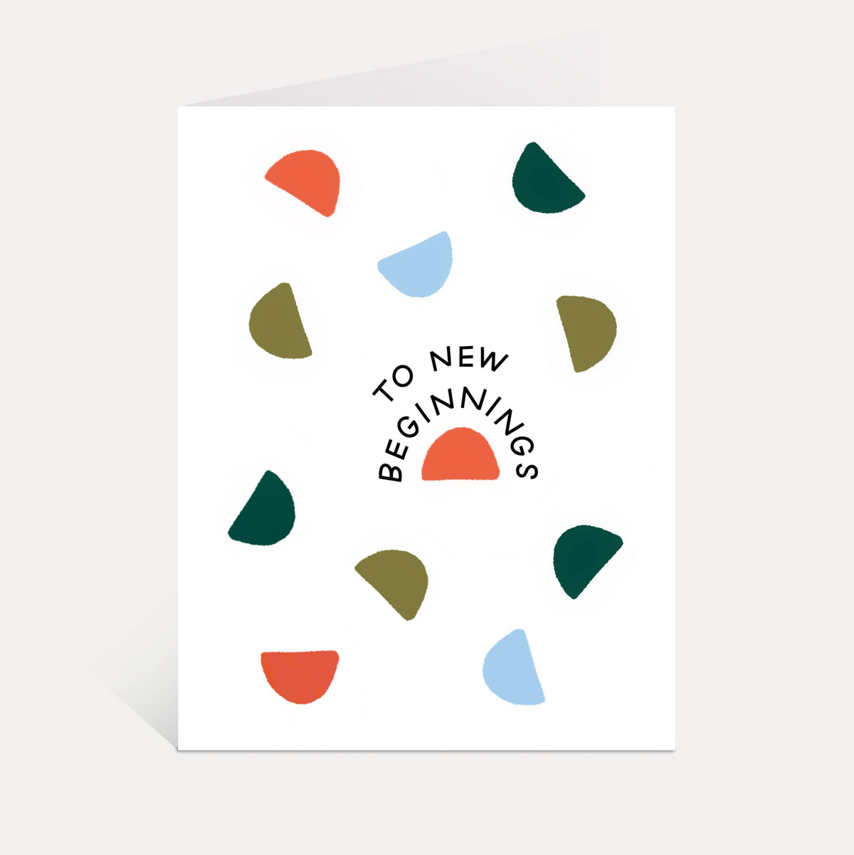 A white greeting card with the phrase 'TO NEW BEGINNINGS' in black curved text
