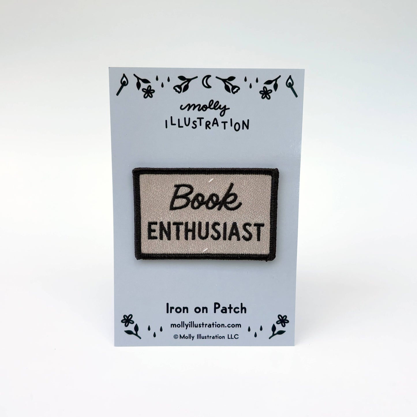 An embroidered iron-on patch reading 'Book ENTHUSIAST