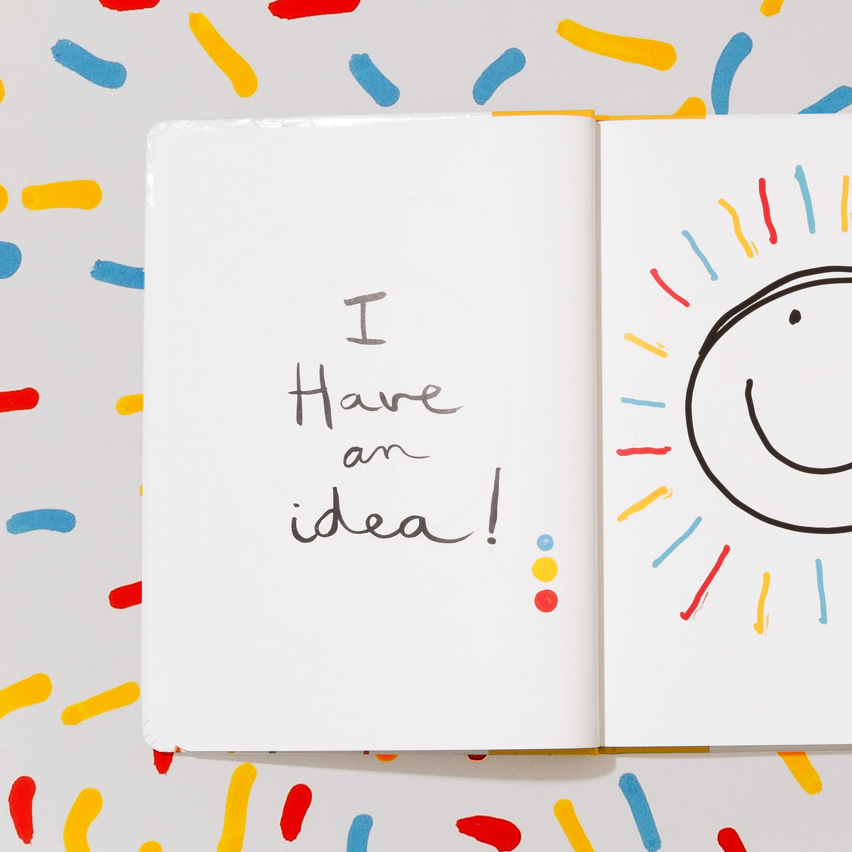 An open children's activity book or journal on a patterned background. 