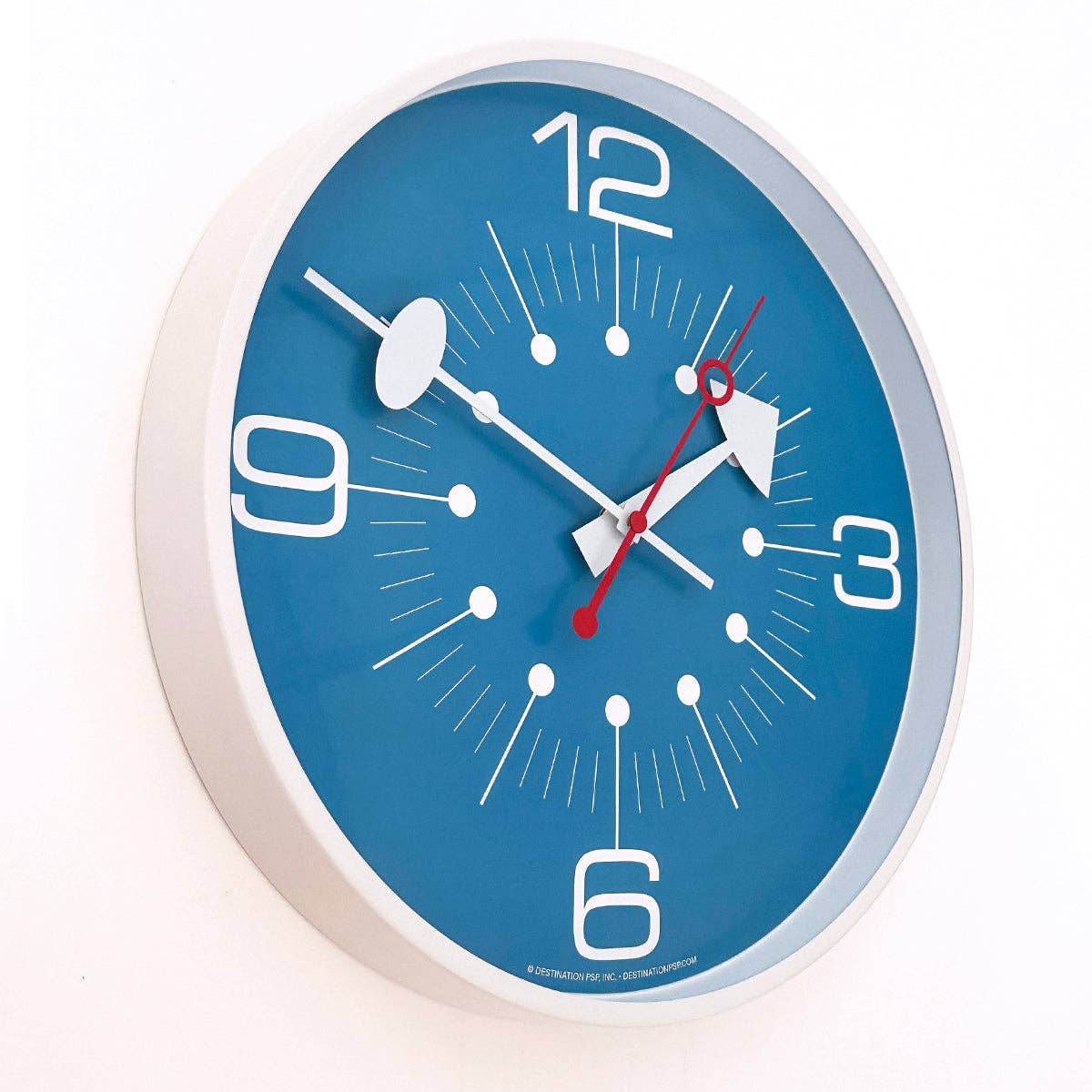 Blue wall clock with white and red accents on a white background