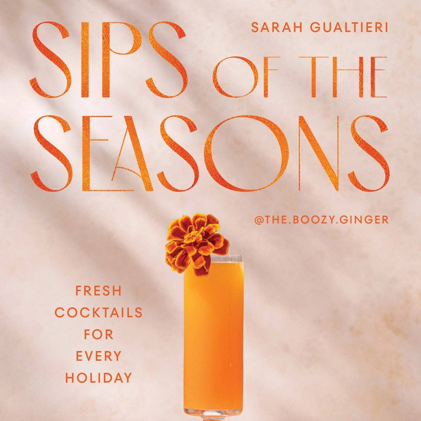 Book cover of 'Sips of the Seasons' with a cocktail and oranges on a neutral background