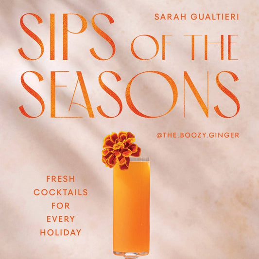 Book cover of 'Sips of the Seasons' with a cocktail and oranges on a neutral background