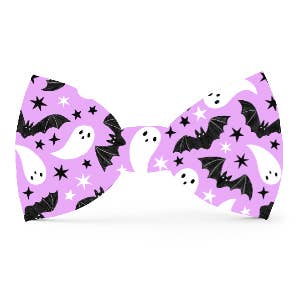 Bow tie with Halloween-themed design featuring ghosts, bats, and stars on a purple background