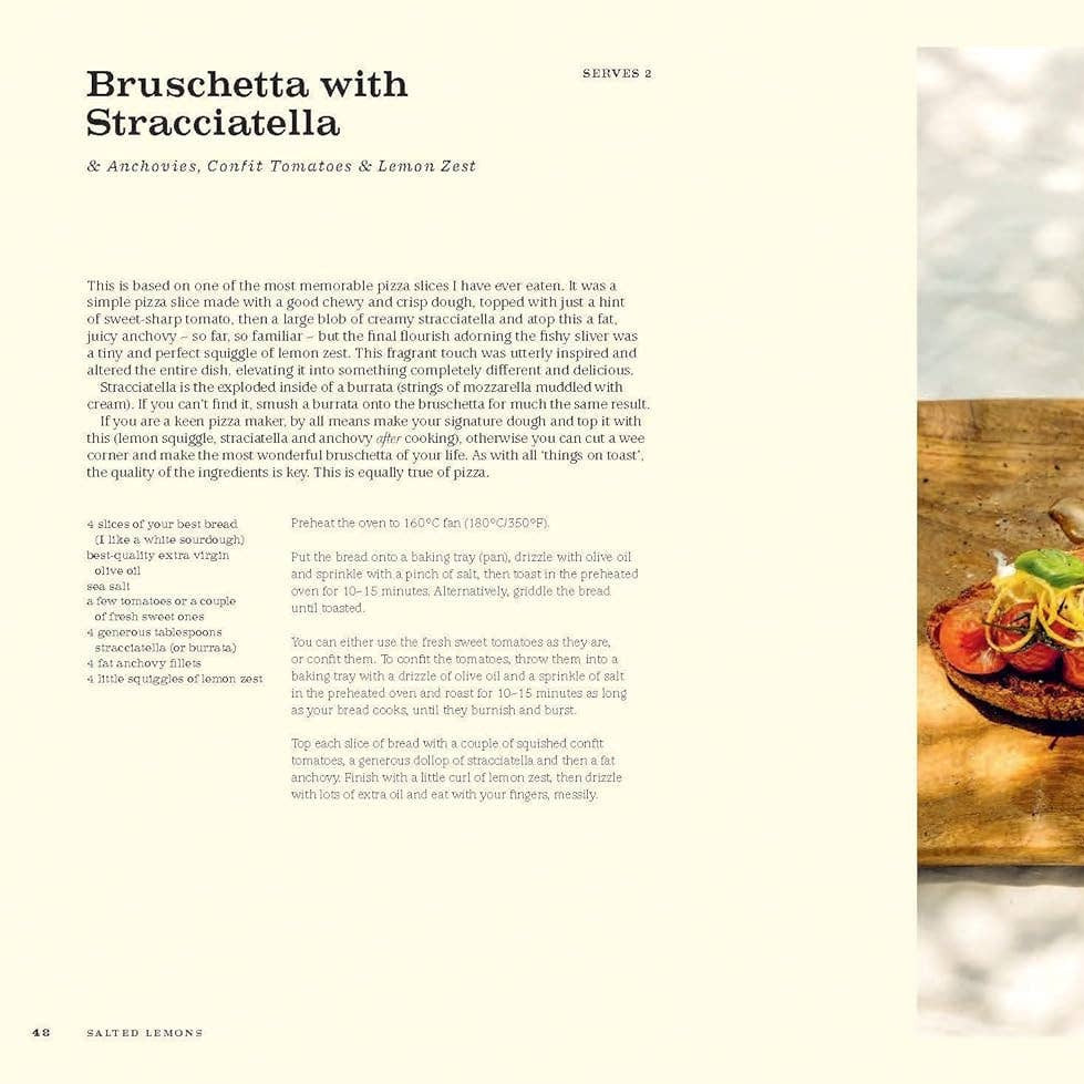 Bruschetta with Stracciatella on a wooden board with a bottle of olive oil.