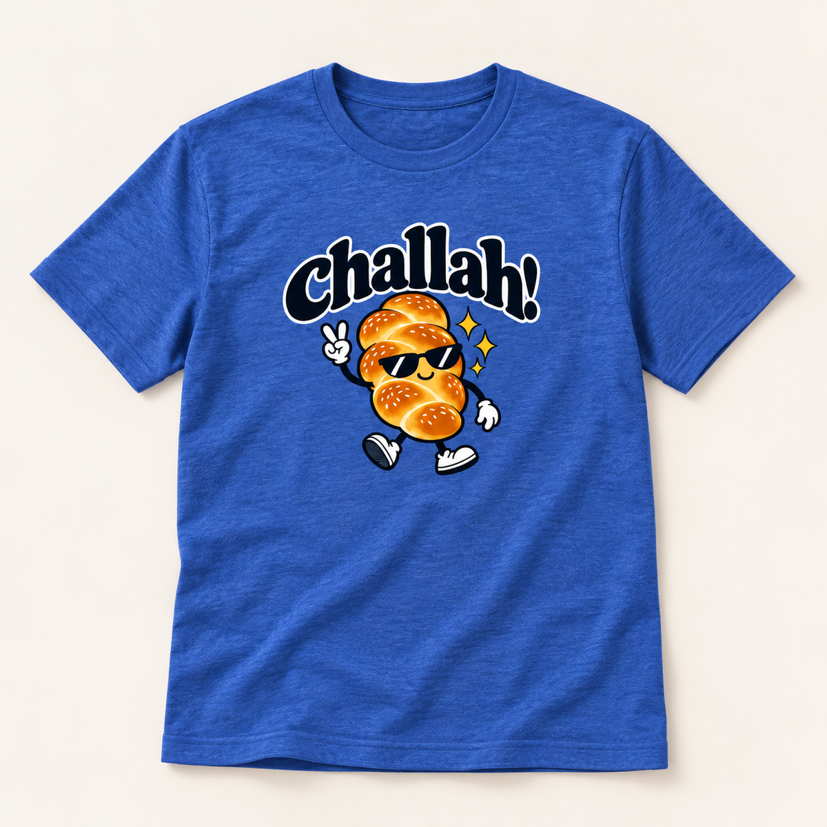 A heather blue short-sleeve t-shirt with a graphic of a walking sesame seed character wearing sunglasses and the word 'Challah!' in black script above it, displayed on a light beige background.