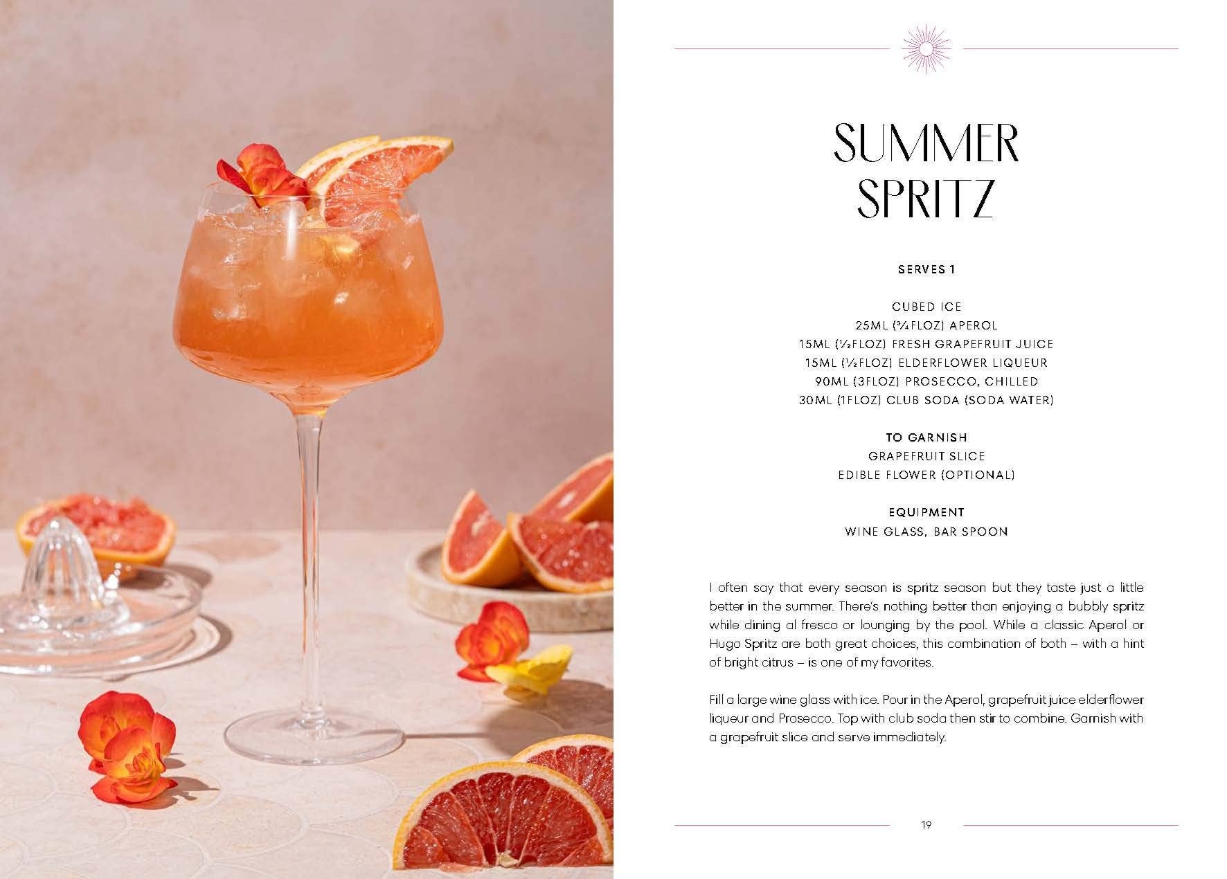 Cocktail in a glass with grapefruit slices and flowers, accompanied by a recipe card for 'Summer Spritz'.
