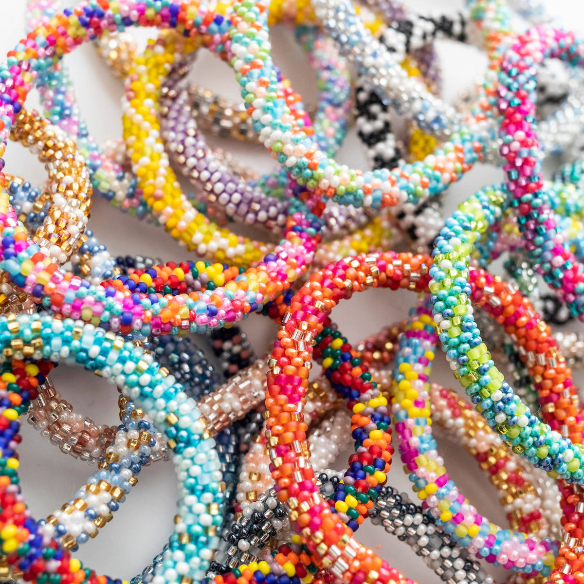 Colorful beaded bracelets on a white background