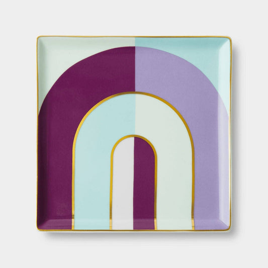 Decorative plate with geometric arch design in purple, green, and white on a light background