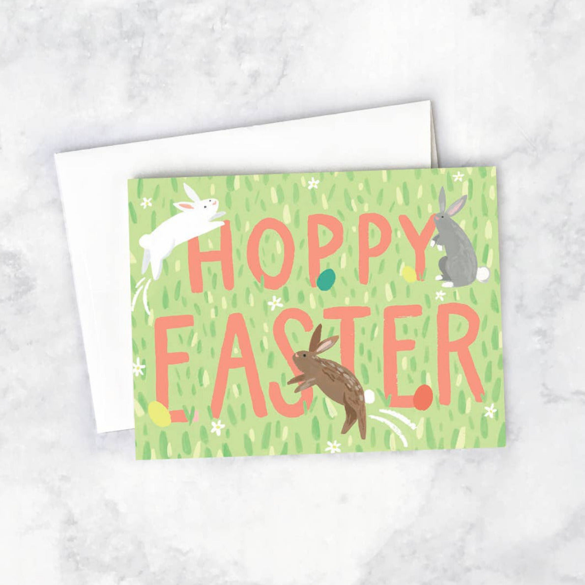 Easter greeting card with bunnies and 'Hoppy Easter' text on a textured white background