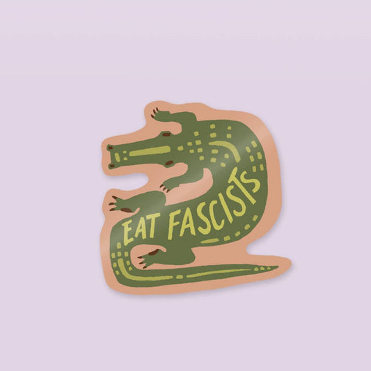 Sticker with a green alligator design and 'Eat Fascists' text on a light purple background