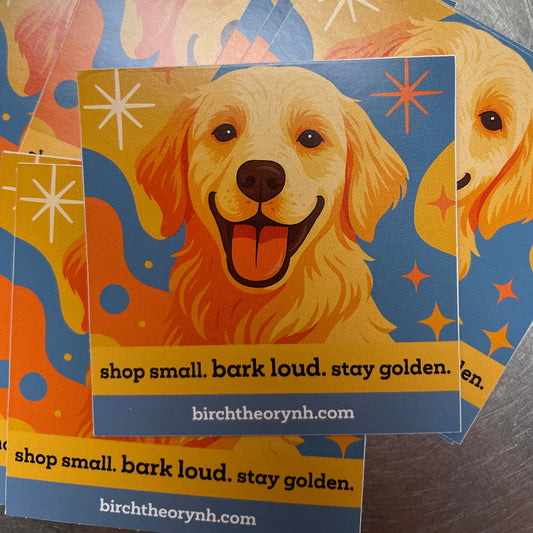 Colorful greeting cards with dog illustrations and text on a metallic surface