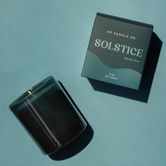 GP Candle Co. Solstice candle and packaging on a teal background