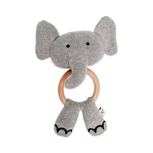 Gray elephant rattle with wooden ring on a white background