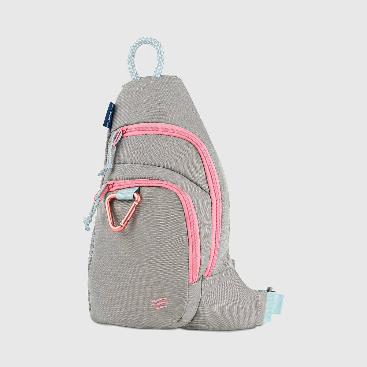 Gray sling bag with pink zippers on a light gray background