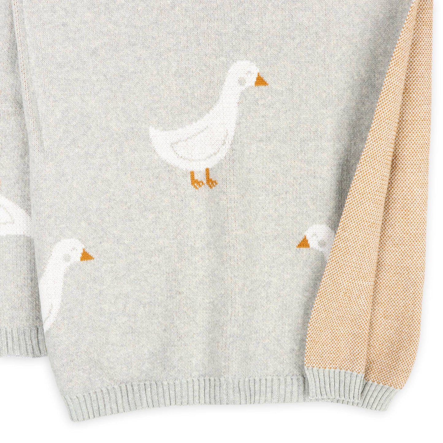 Gray sweater with white duck designs on a white background