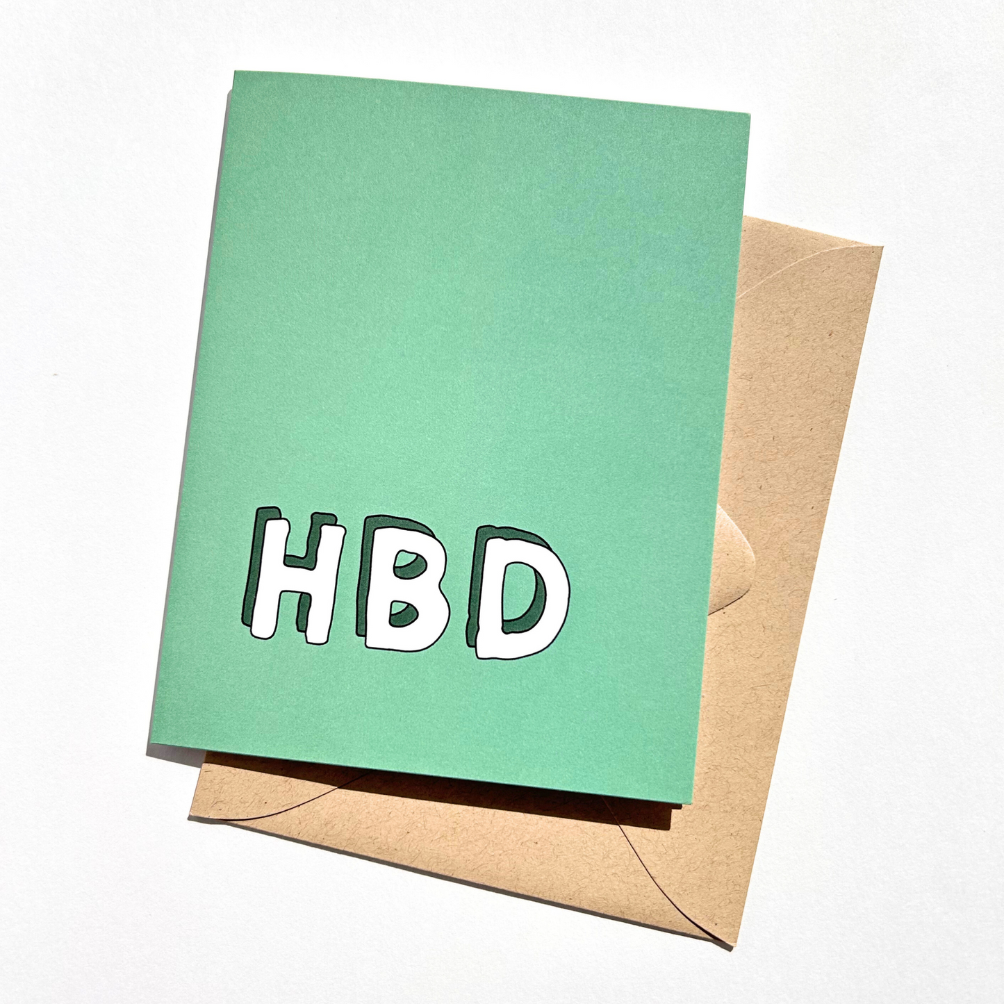 Green card with 'HBD' text and brown envelope on white background