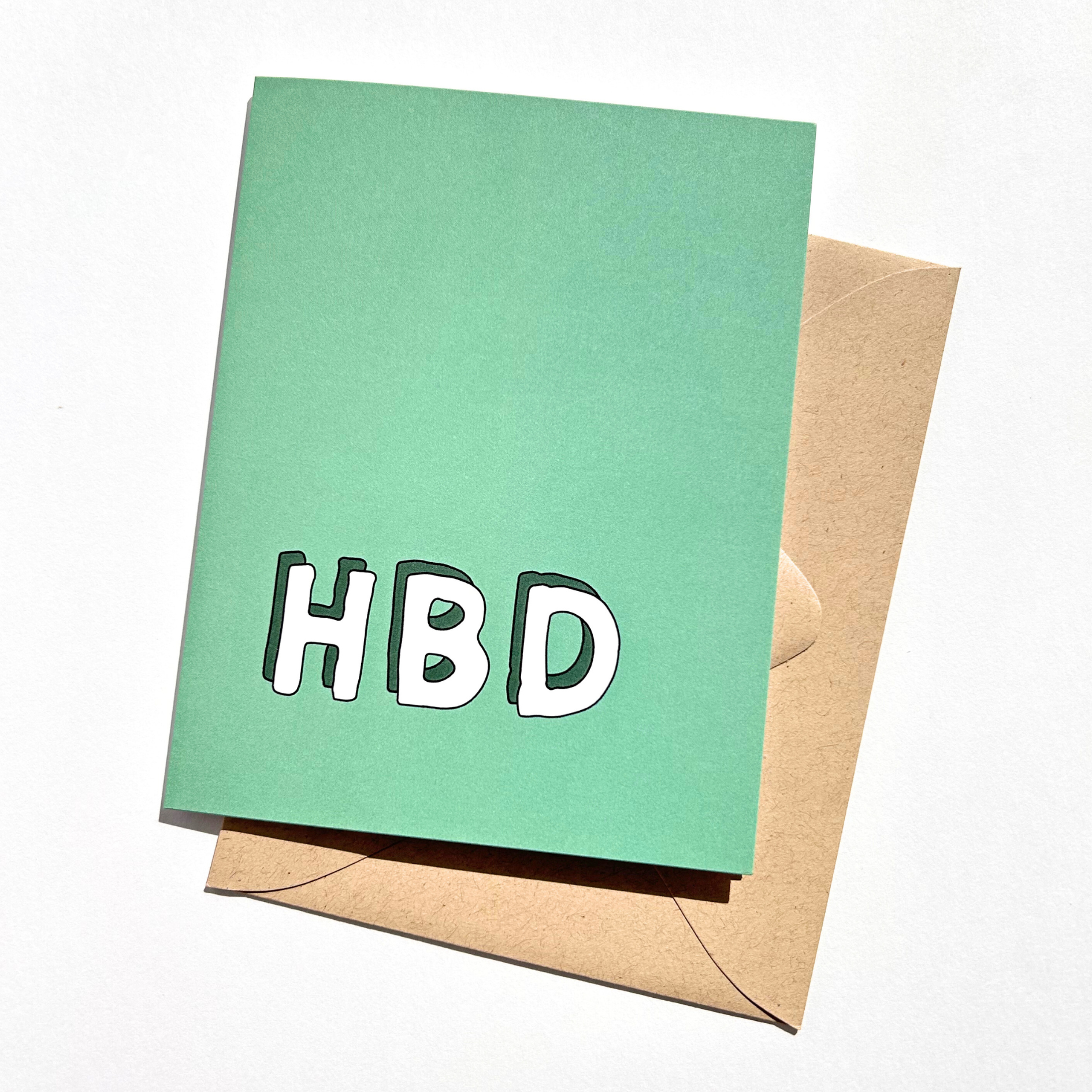 Green card with 'HBD' text and brown envelope on white background