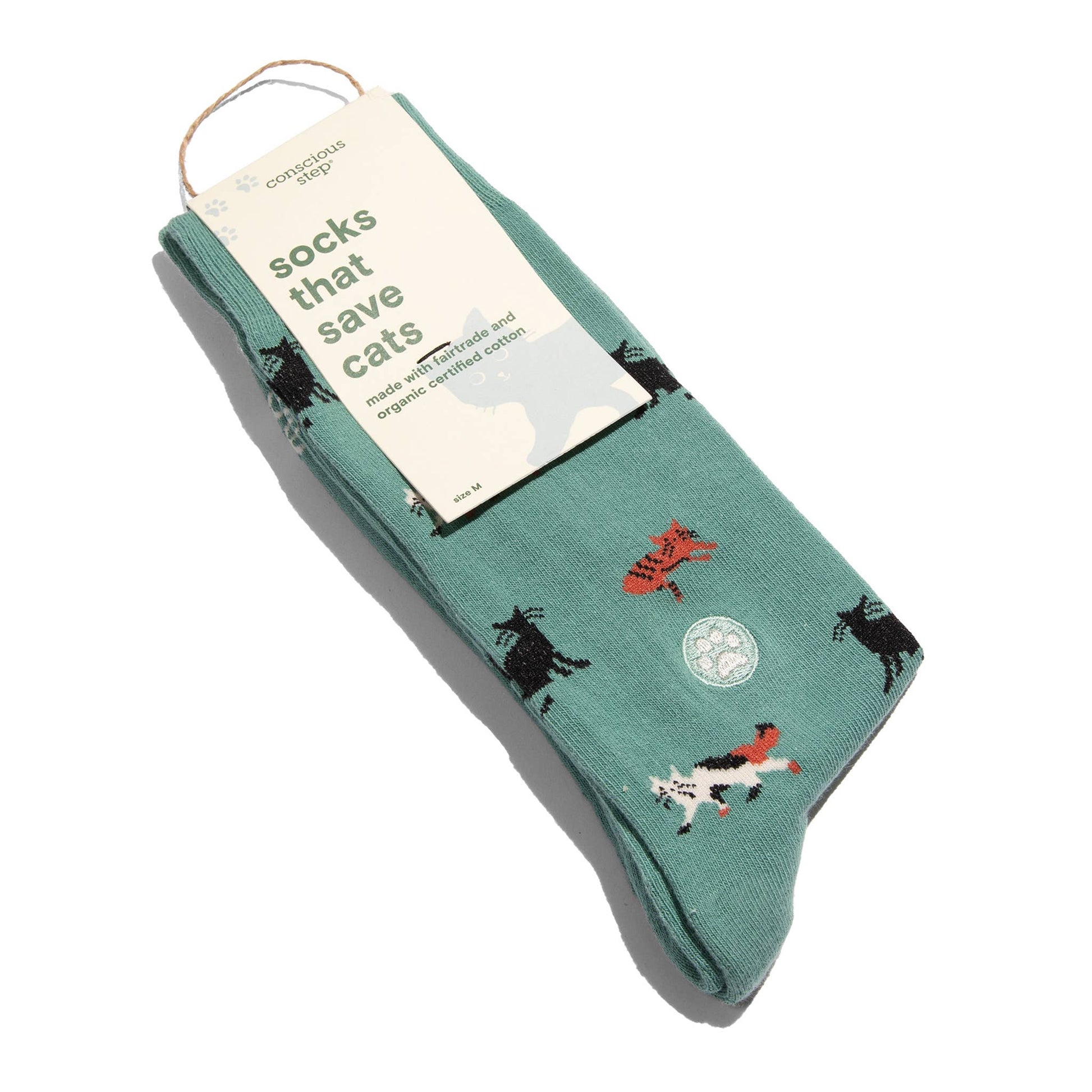 Green socks with cat designs on a white background
