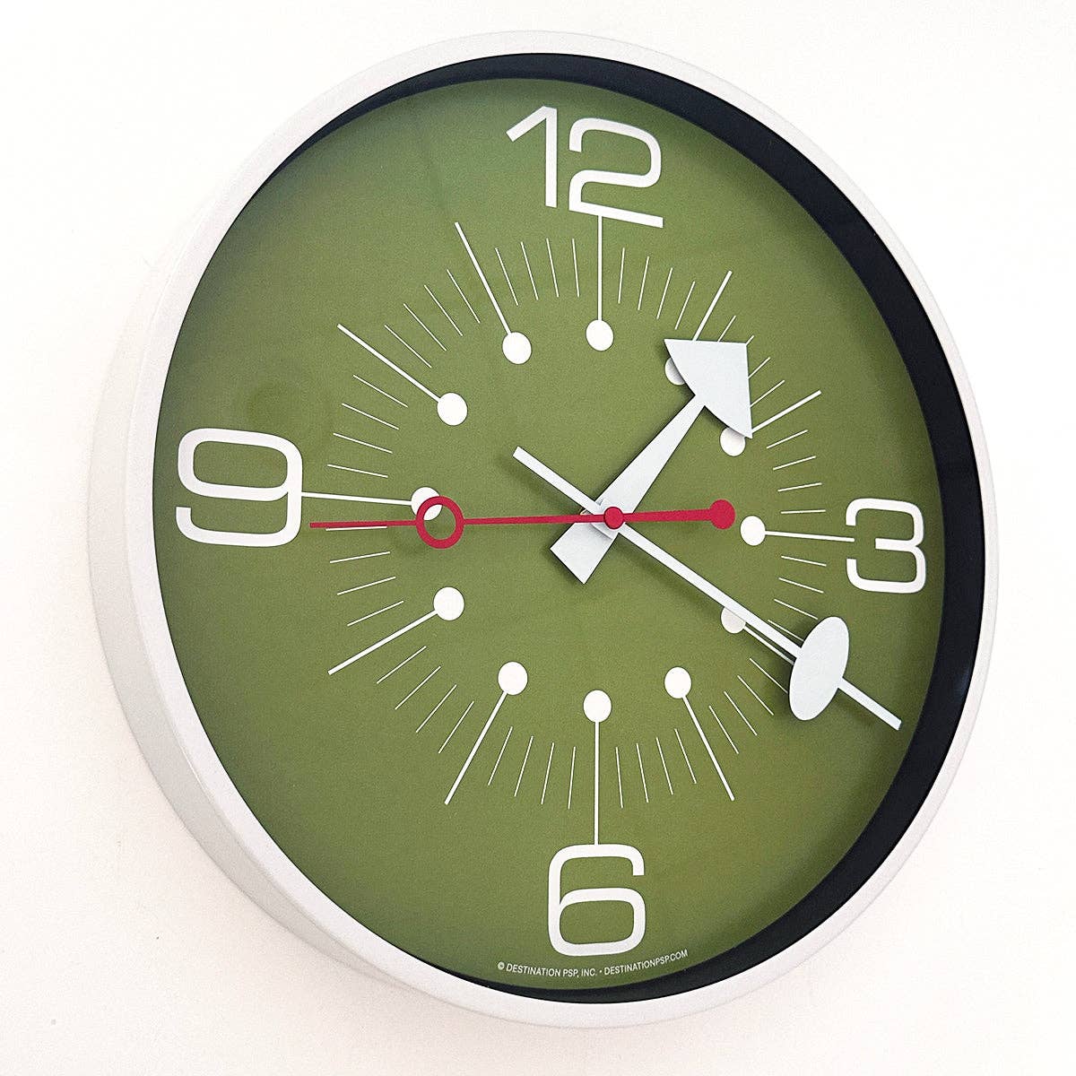 Green wall clock with white numbers and hands on a white background