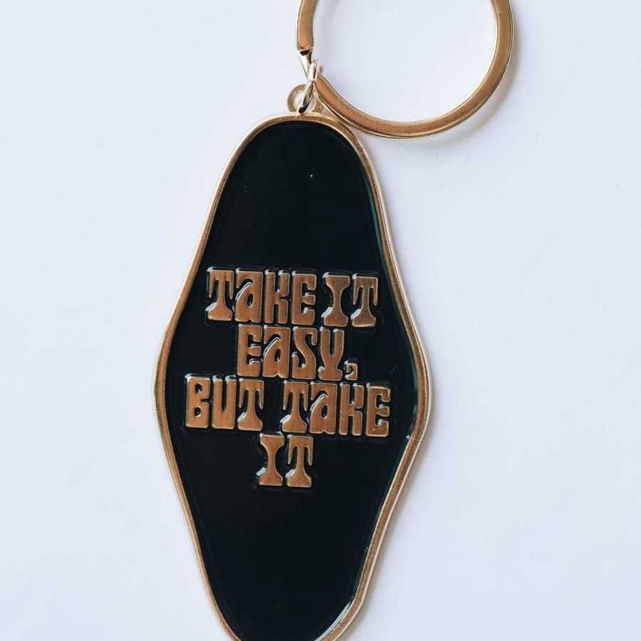 Keychain with 'Take It Easy, But Take It' text on a black background