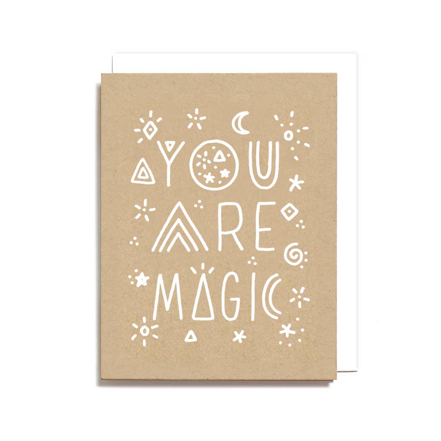 Kraft paper card with 'You are magic' text and decorative elements on a white background