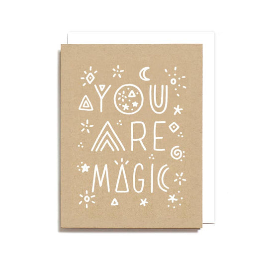 Kraft paper card with 'You are magic' text and decorative elements on a white background