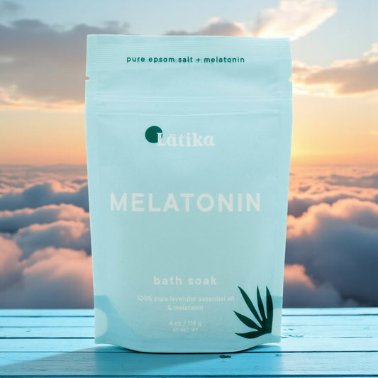 Latika Melatonin bath soak package with a sunset and clouds in the background