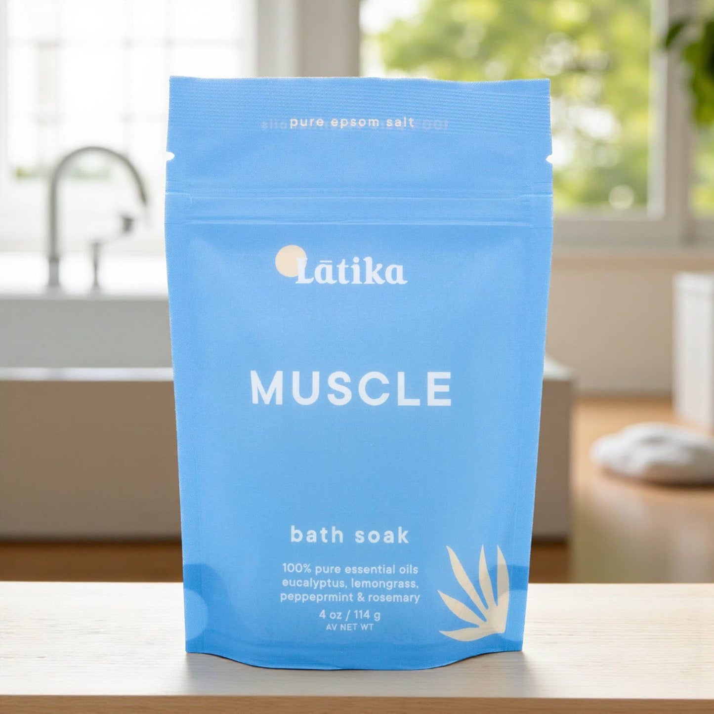 Blue package of Latika Muscle bath soak on a surface with a blurred background