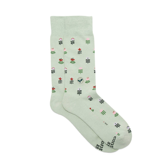 Light green sock with floral pattern on a white background