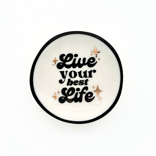 Round white coaster with 'Live your best life' text and decorative stars on a white background