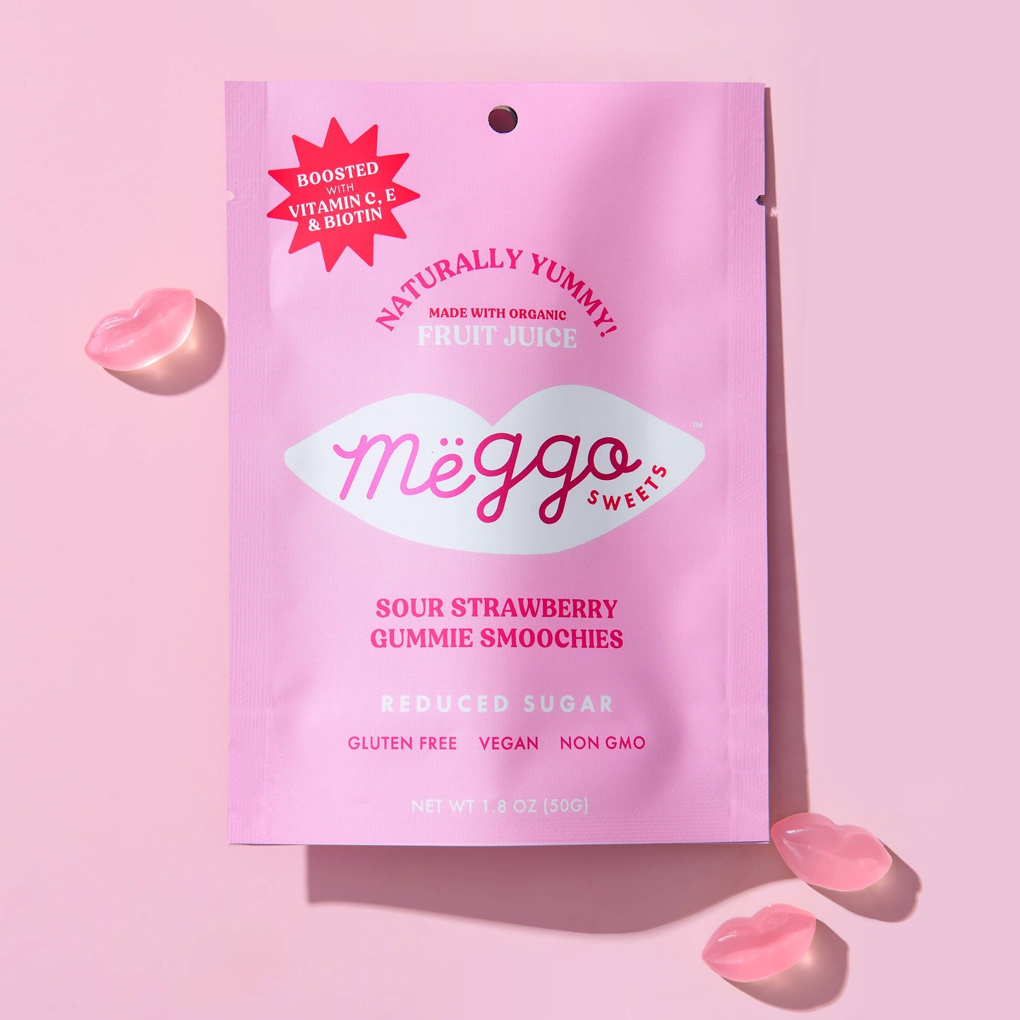 Pink package of Méggo Sweets Sour Strawberry Gummy Smoochies on a pink background