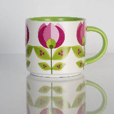 Mug with floral design on a reflective surface