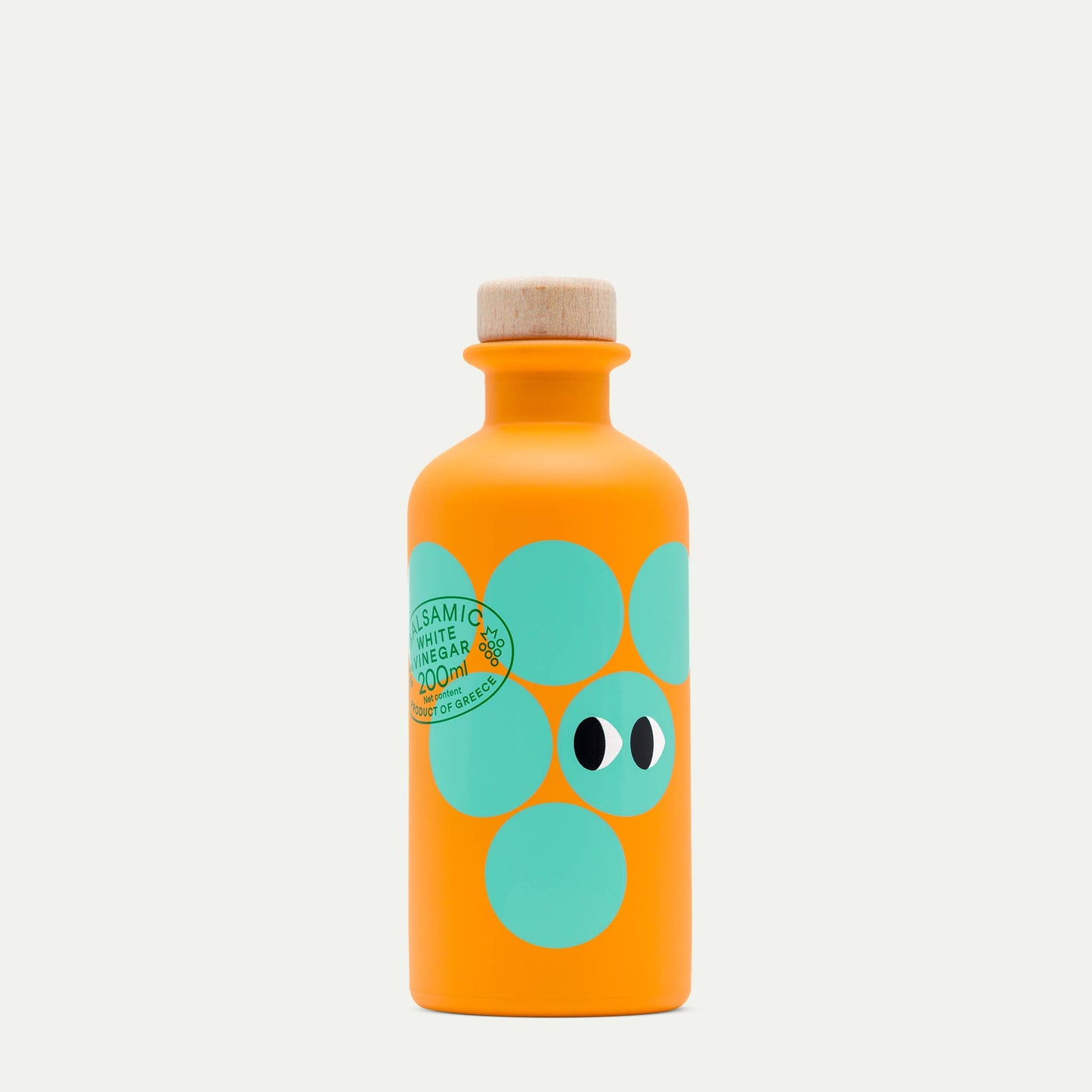 Orange bottle with green polka dot design on a white background