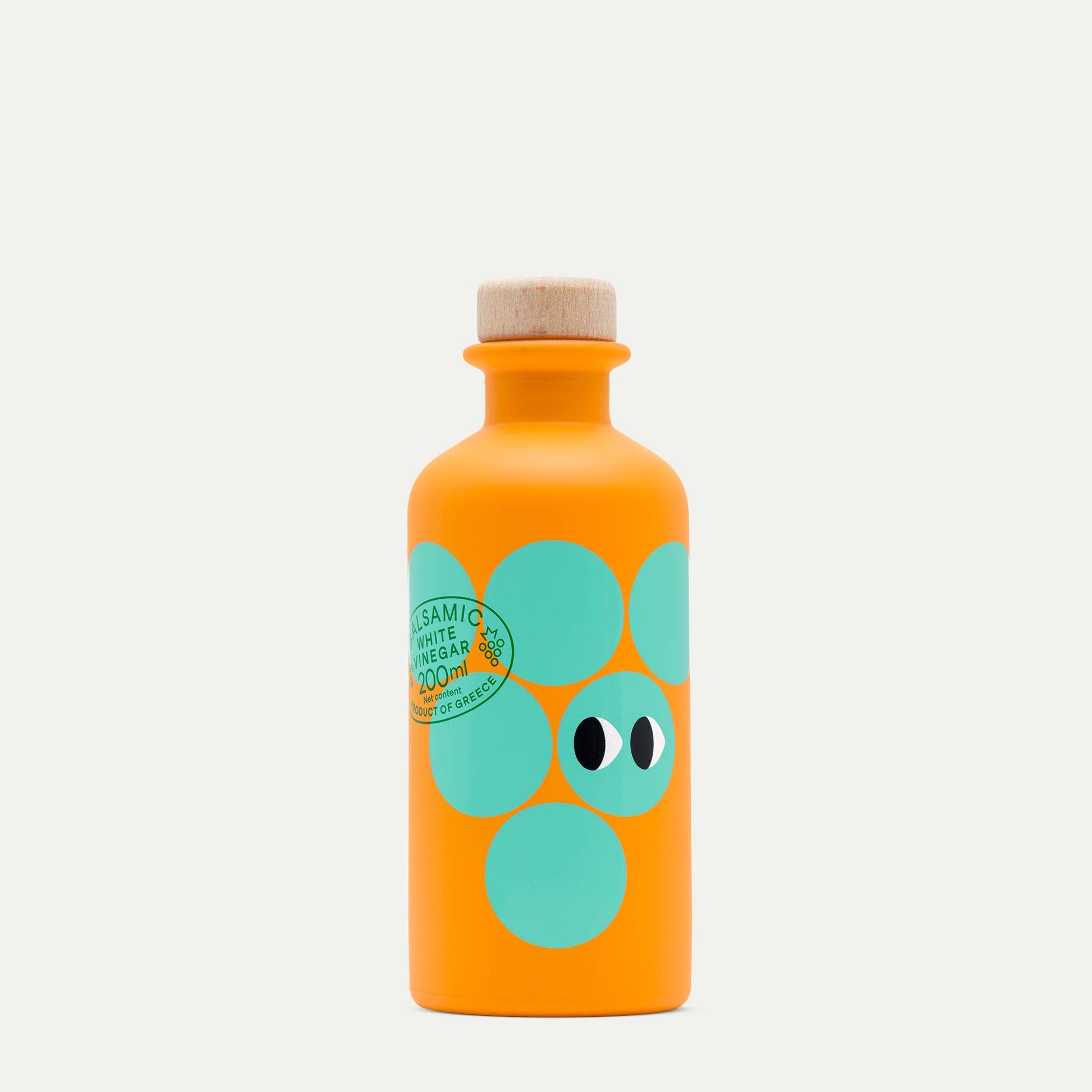 Orange bottle with green polka dot design on a white background