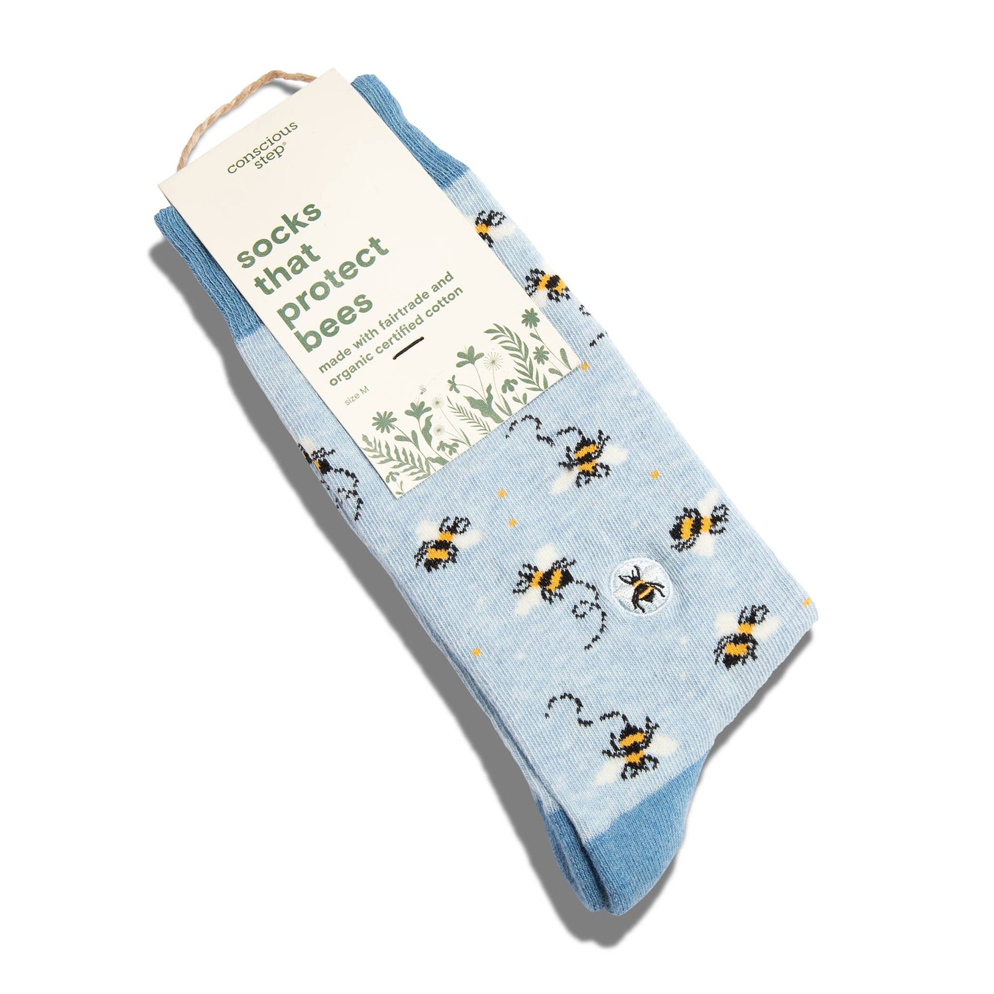 Packaged socks with bee design and visible brand label on a white background