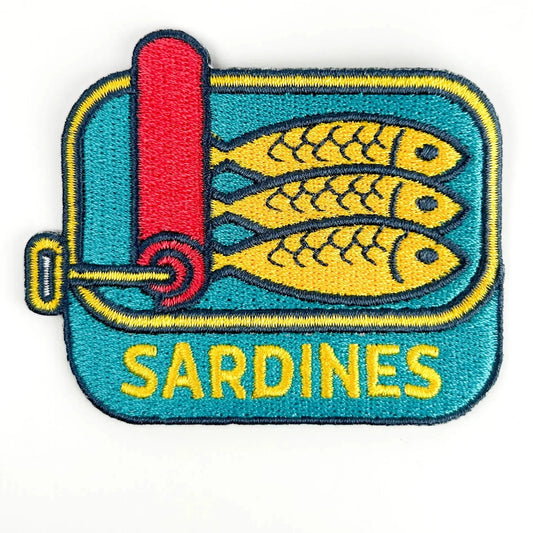 Patch of a sardine can with two yellow fish on a blue background