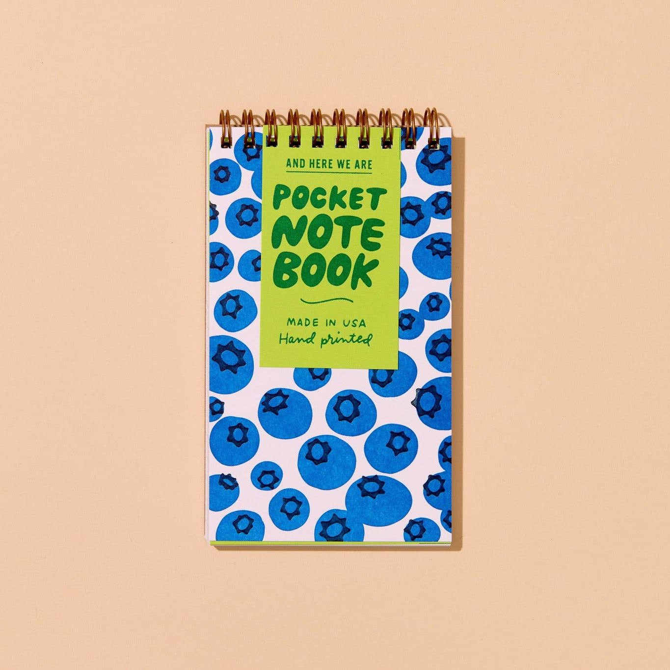 Pocket notebook with blueberry pattern on a beige background