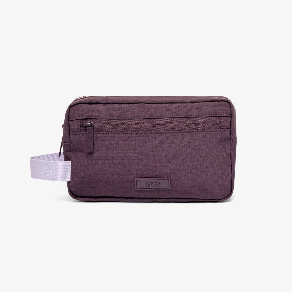 Purple travel pouch with a white strap on a light gray background