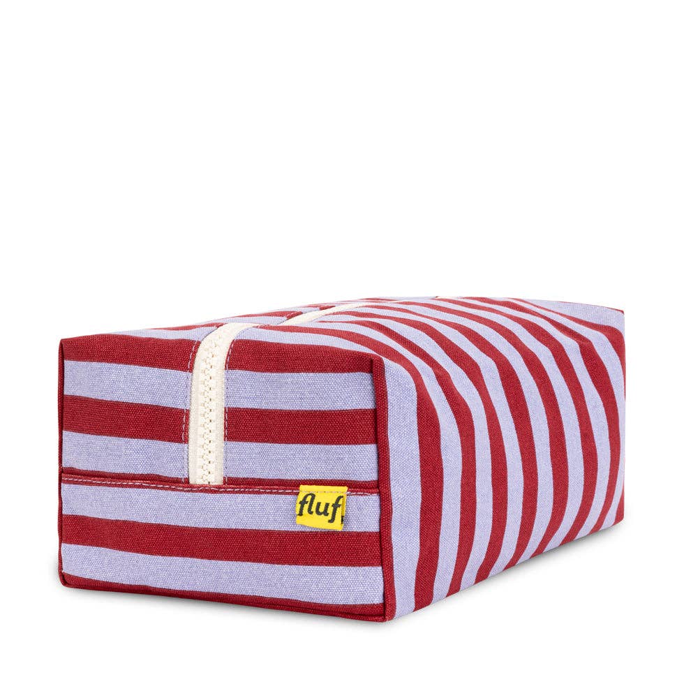 Red and white striped pet bed with 'fluf' label on a white background