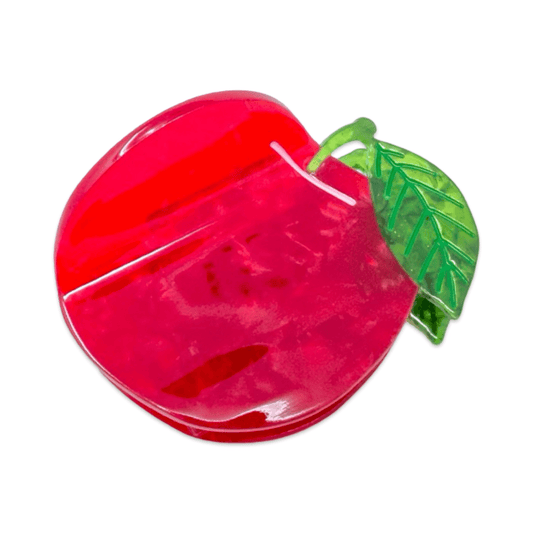 Red apple-shaped clip with a green leaf on a white background
