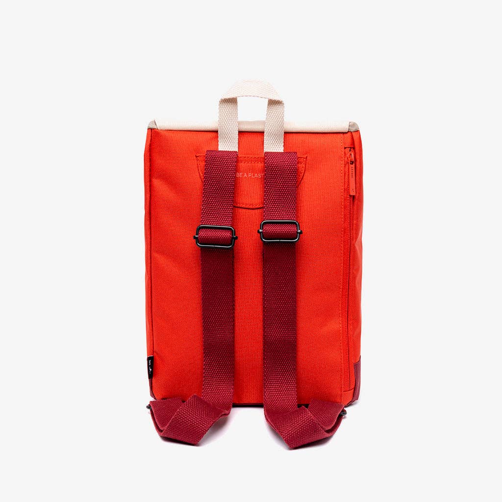 Red backpack with straps on a white background