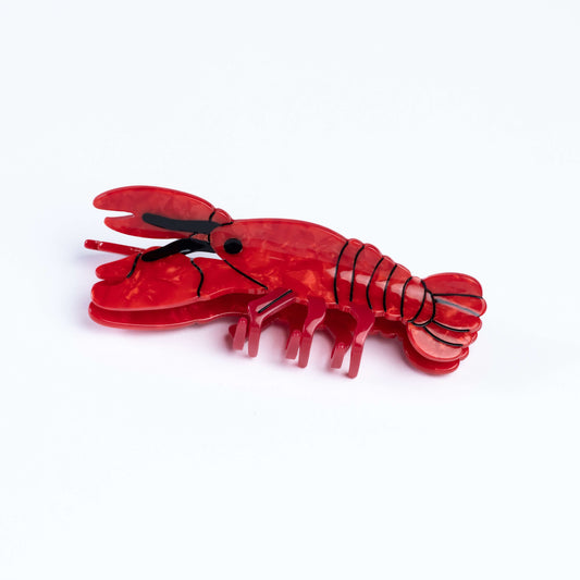 Red lobster-shaped hair clip on a white background