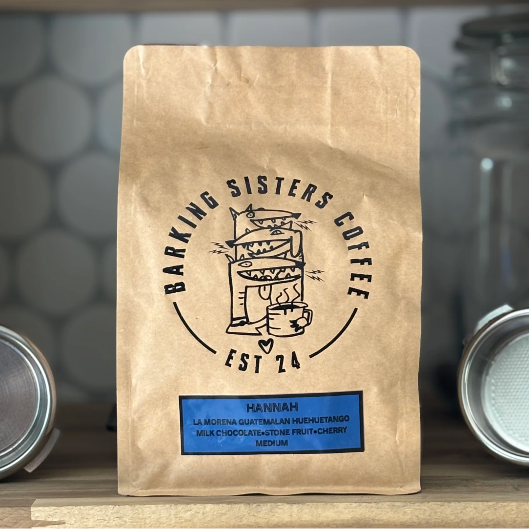Barking Sisters Coffee package with branding and product details on a blurred background