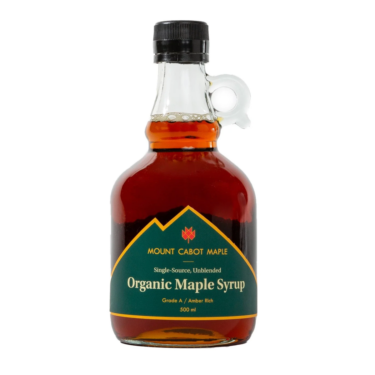 A 500 ml bottle of Mount Cabot Maple Organic Maple Syrup, featuring amber-brown syrup inside a clear glass bottle with a black cap and a green label.