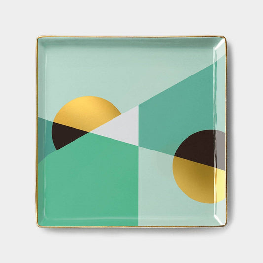 Square ceramic plate with geometric design on a light gray background
