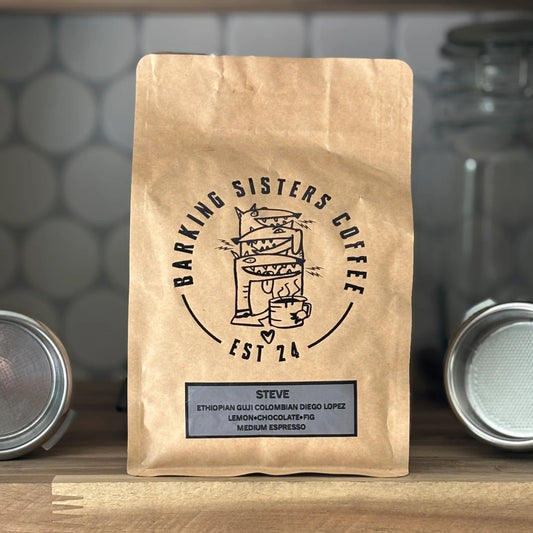 Barking Sisters Coffee package on a wooden shelf with a blurred background