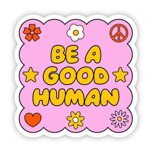 Sticker with 'Be a Good Human' text on a pink background with decorative elements.