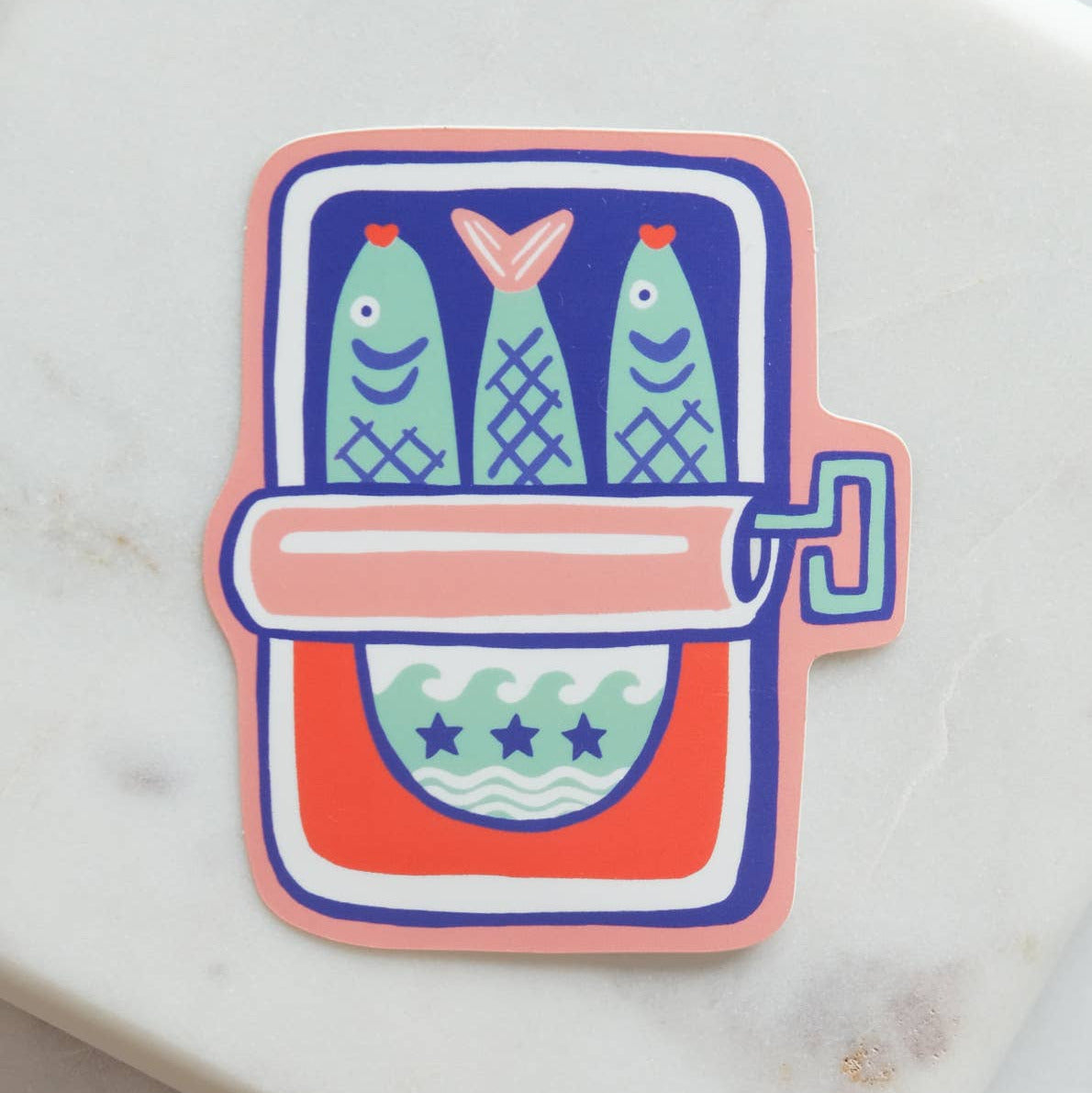Sticker with a design of three fish in a refrigerator on a marble surface